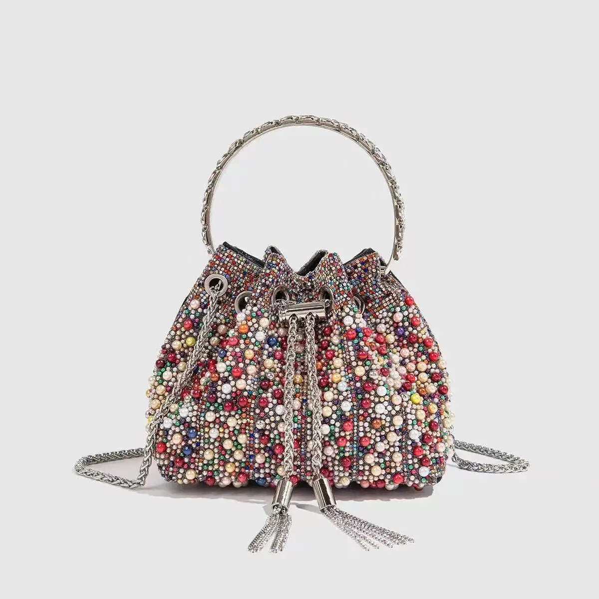 A crystal-embellished evening clutch featuring a beaded surface and a silver chain strap.