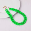 A bright green acrylic chain necklace with a gold-colored clasp is displayed on a white background.