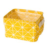 A bright yellow foldable cotton linen storage basket with a geometric pattern and handles.