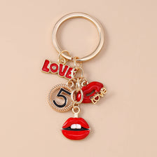 Gold-toned enamel heart keychain featuring the word Love and the number 5
