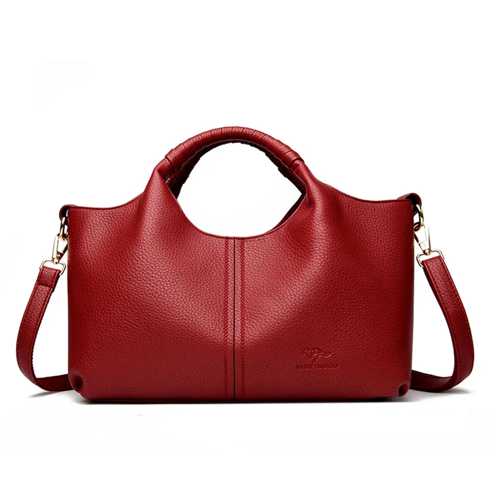 A deep red luxury soft leather women's tote bag with a handle and gold hardware.