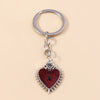 Silver keychain featuring a heart pendant with a red background and an eye design