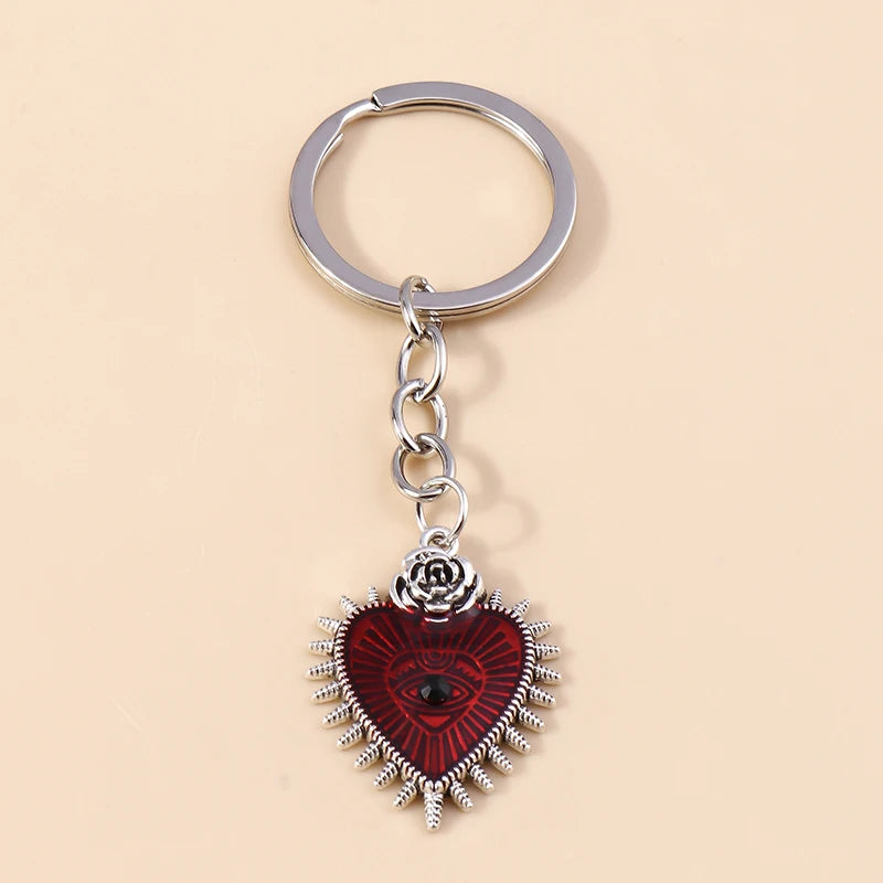 Silver keychain featuring a heart pendant with a red background and an eye design