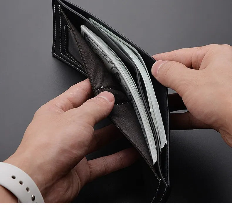A hand is opening a black PU leather folding wallet to show the contents.