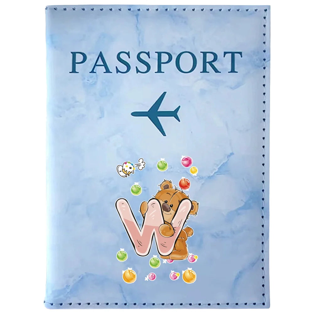 Light blue passport card holder with a vintage letter print featuring an airplane and a bear's paw print.