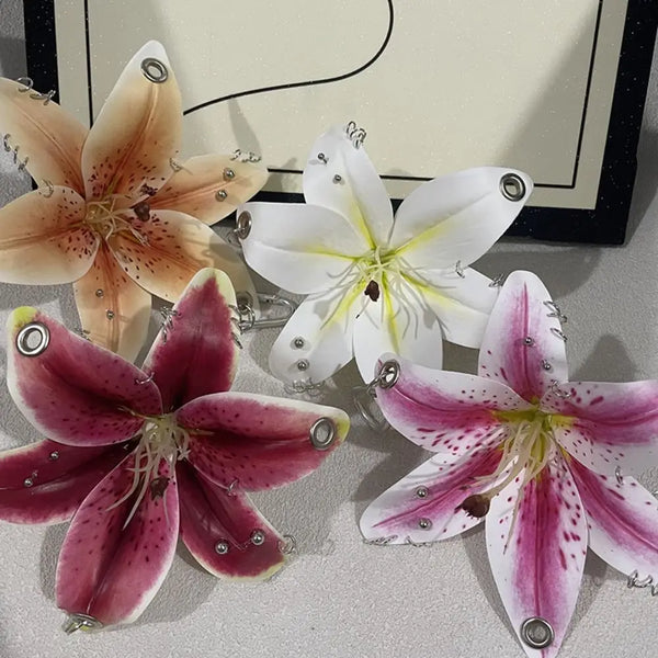 A collection of realistic orchid flowers in various colors including peach, white, and pink, displayed on a light surface.