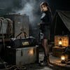 A woman in dark clothing stands next to vintage storage boxes and equipment in a dimly lit, rugged outdoor setting.
