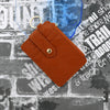 A brown PU leather card holder wallet with a quilted design is shown against a textured gray background.