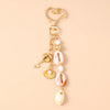 Gold and pink seashell starfish keychain with pearl accents