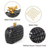 A black handwoven clutch bag featuring a refined woven texture finish and gold metal snap fasteners and chain.