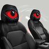 A set of two black car headrest covers with red eyes are shown against a gray background.