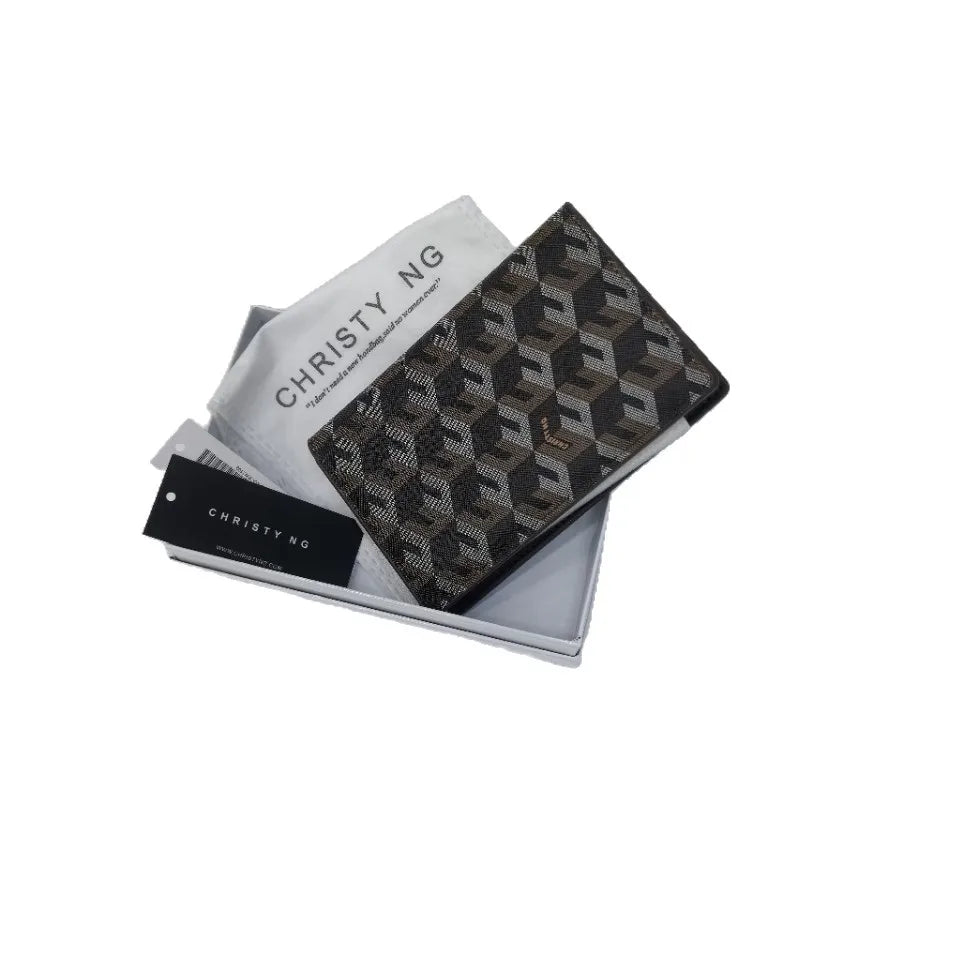 A black geometric print passport wallet for women shown in a light gray sleeve.
