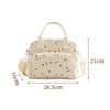 A beige floral corduroy insulated lunch bag with a light yellow strap and star pattern.
