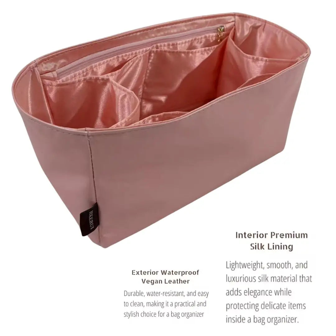 A pink luxury bag organizer insert featuring a satin silk lining and waterproof vegan leather exterior.