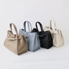 Four genuine leather women's shoulder tote bags in beige, blue-gray, black, and cream.