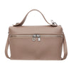 A beige pebbled leather box crossbody bag with a zipper closure and leather strap.