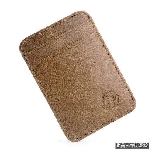 A brown genuine leather card holder with a stitched edge and embossed logo.