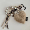 Brown leather heart pendant keychain featuring pearl beads and a long tassel