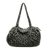 A leopard print canvas tote bag with an adjustable shoulder strap.