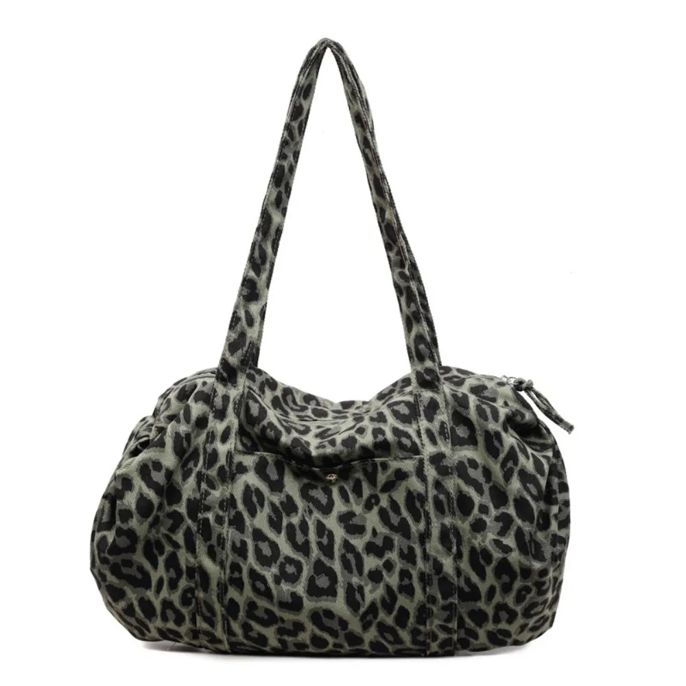 A leopard print canvas tote bag with an adjustable shoulder strap.