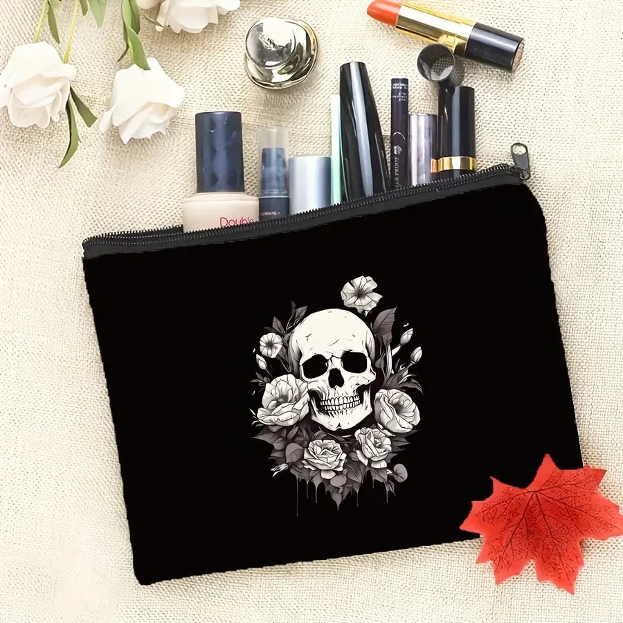 Black makeup pouch featuring a detailed illustration of a skull surrounded by roses