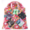 A pink floral print tote bag featuring various colorful flower patterns and a transparent pocket.