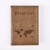 A brown leather passport holder with the word PASSPORT and a world map silhouette embossed on the cover.