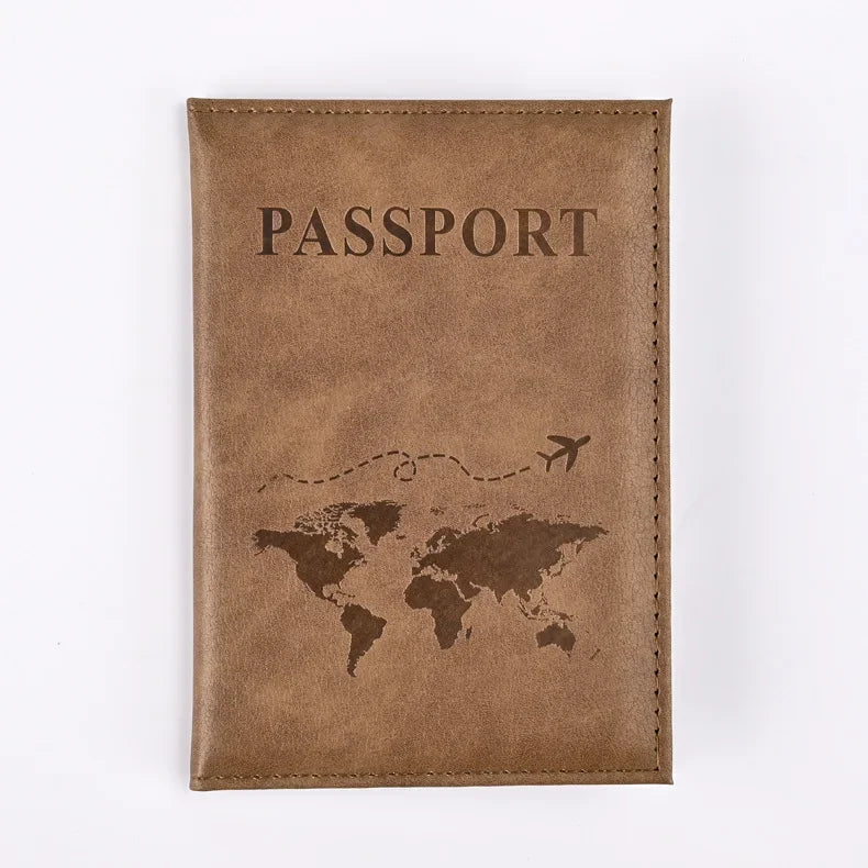 A brown leather passport holder with the word PASSPORT and a world map silhouette embossed on the cover.
