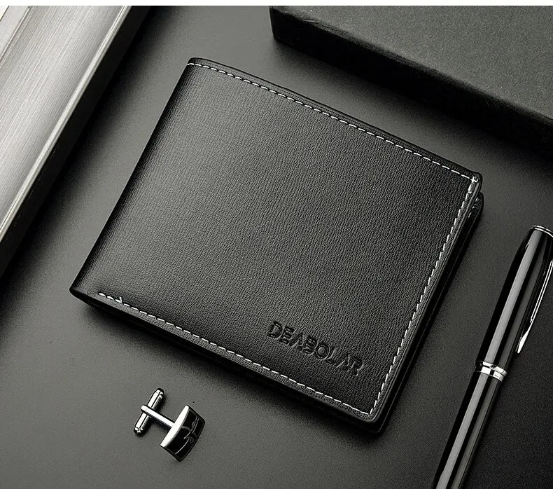 A black men's PU leather folding wallet resting on a dark surface next to a pen.