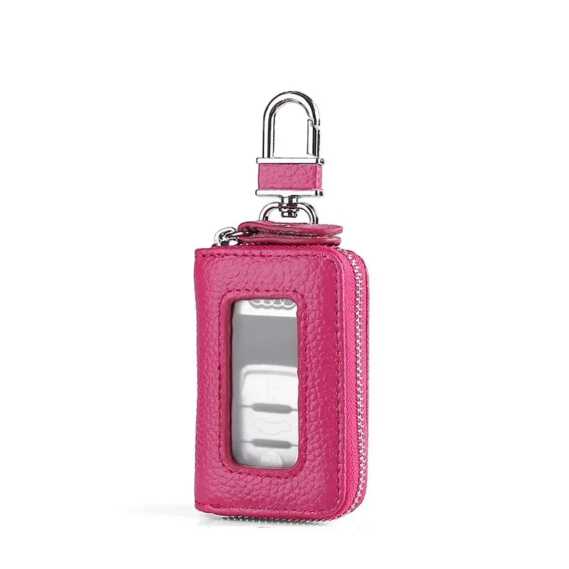 A pink leather car key case with a transparent window and a silver padlock.