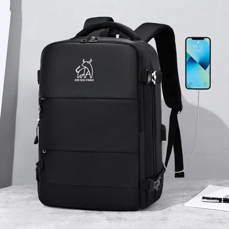 A black expandable travel backpack with a logo on the front, shown next to a smartphone.