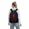 A person is wearing a black backpack featuring a red spider design on a white long-sleeved shirt.