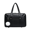 Black leather preppy shoulder bag with a white pom-pom detail