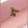 A close-up of a pink tri-fold PU card holder wallet featuring a gold-toned corner clasp.