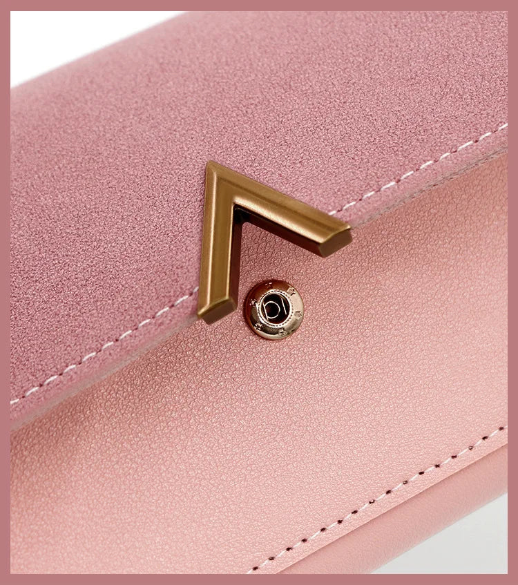 A close-up of a pink tri-fold PU card holder wallet featuring a gold-toned corner clasp.