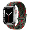 A silver Apple Watch is shown with a dark green braided stretch band wrapped around it.