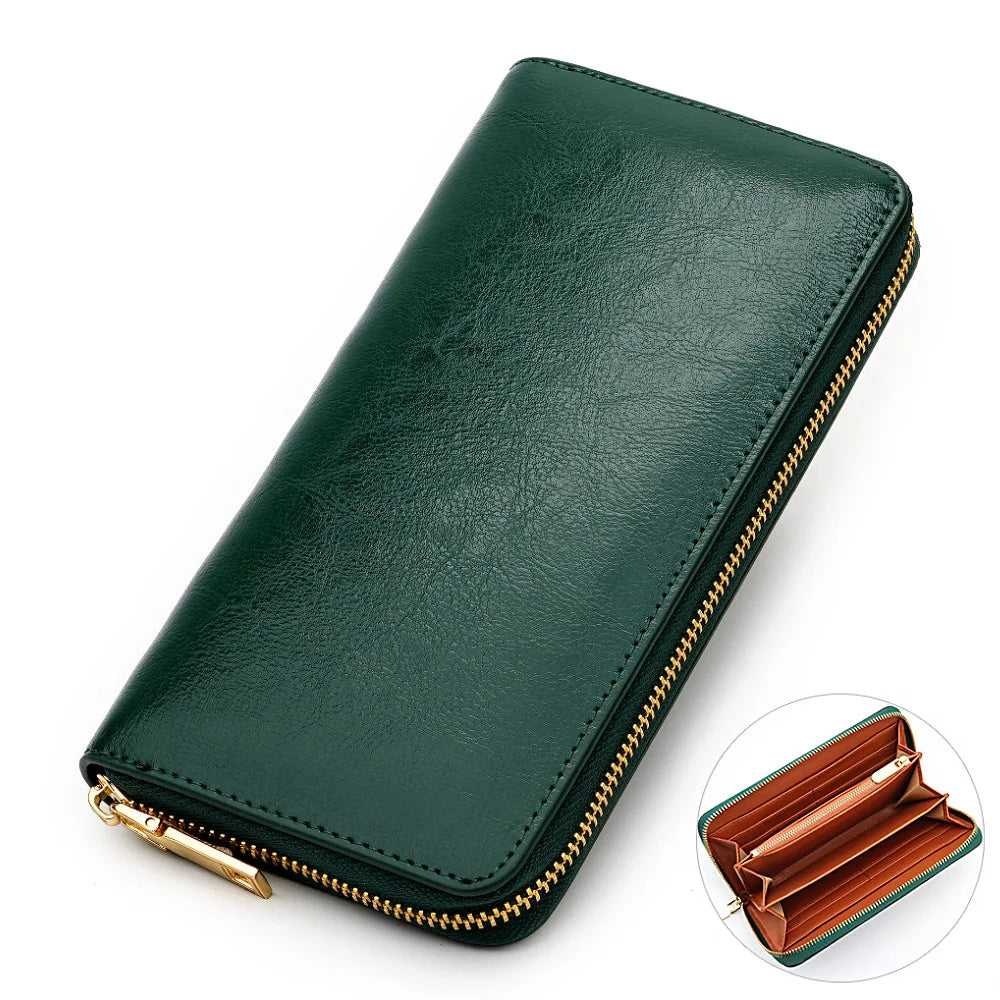 A dark green genuine leather zipper wallet shown in a diagonal angle with an open view of the interior.