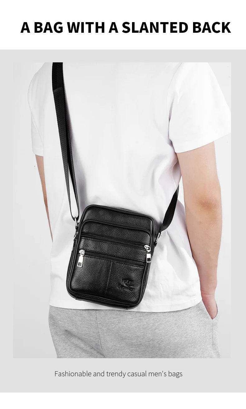 A black leather messenger bag with a slanted back worn by a man in a white t-shirt.