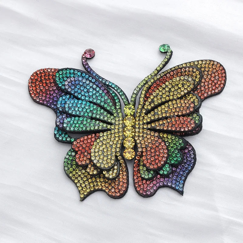 A colorful decorative rhinestone butterfly applique sticker with iridescent wings.