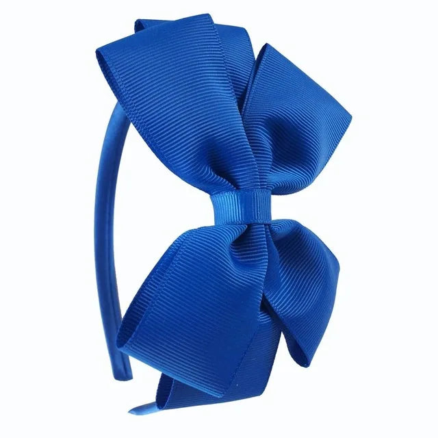 A bright blue satin bow headband is shown against a white background.