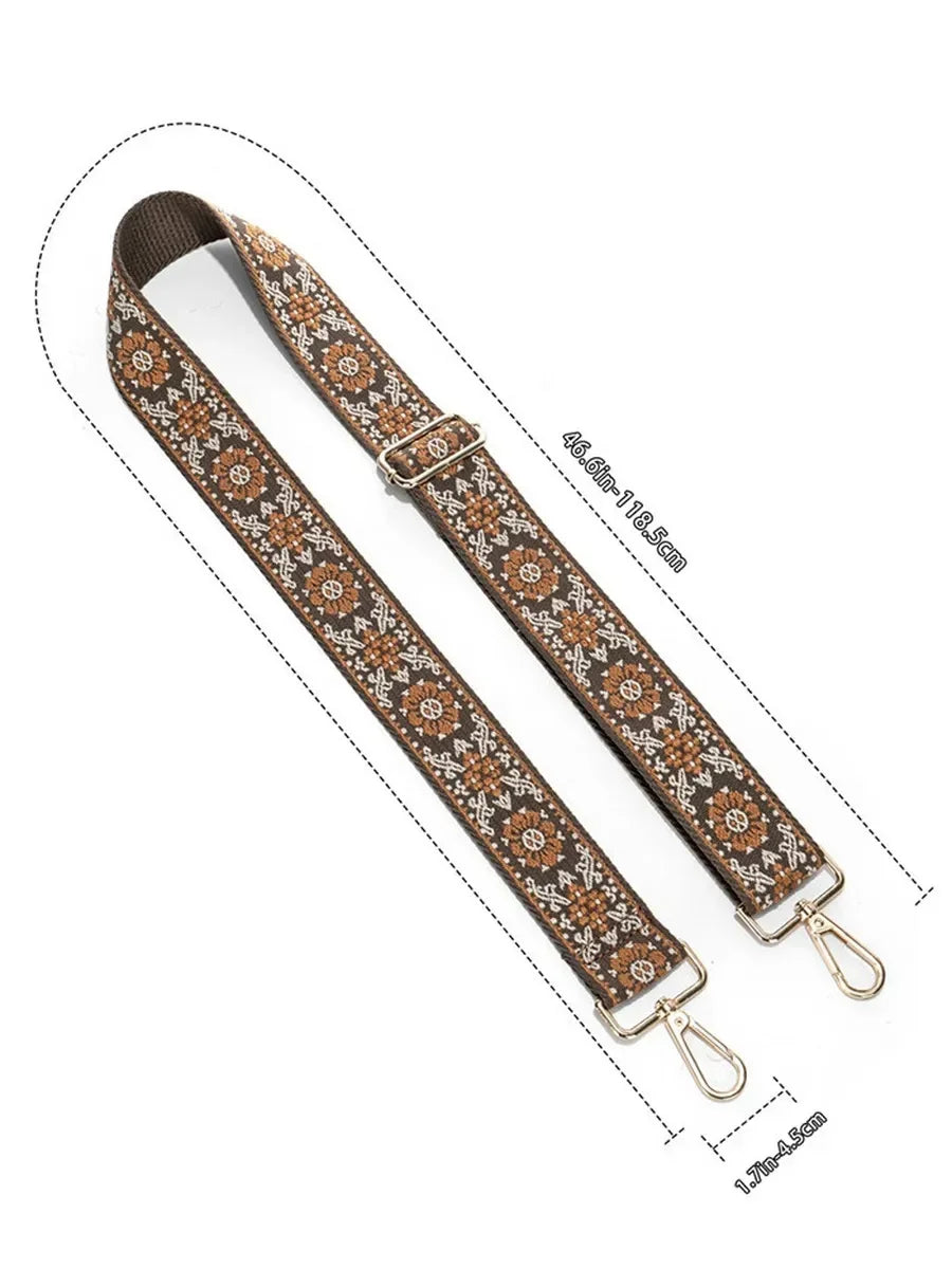 A brown and beige patterned textile replacement bag strap with metal clasps.