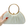 A hand holds an elegant satin pleated evening clutch bag with a gold rim and light beige fabric.