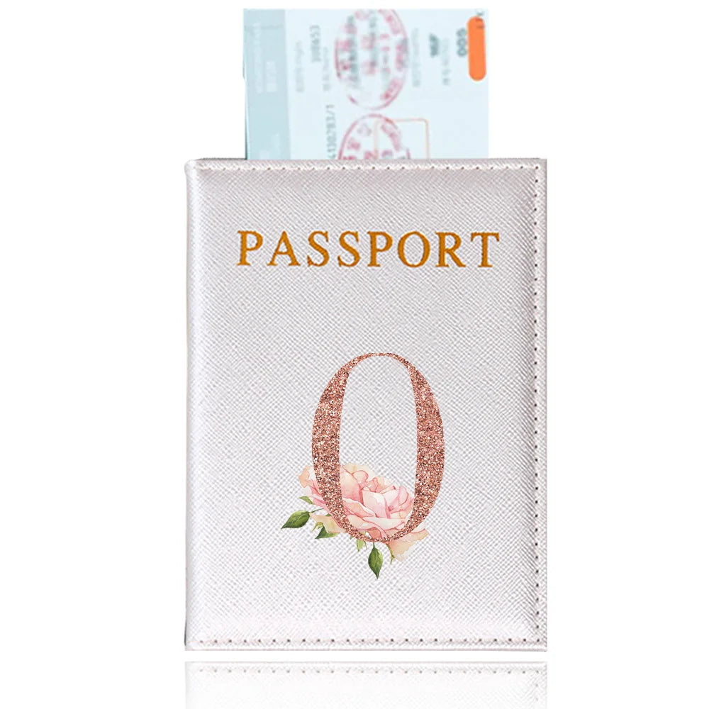 A pink leather passport holder featuring a rose design and a passport inside.