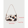 A brown cow print single shoulder bag with an adjustable strap shown against a light background.