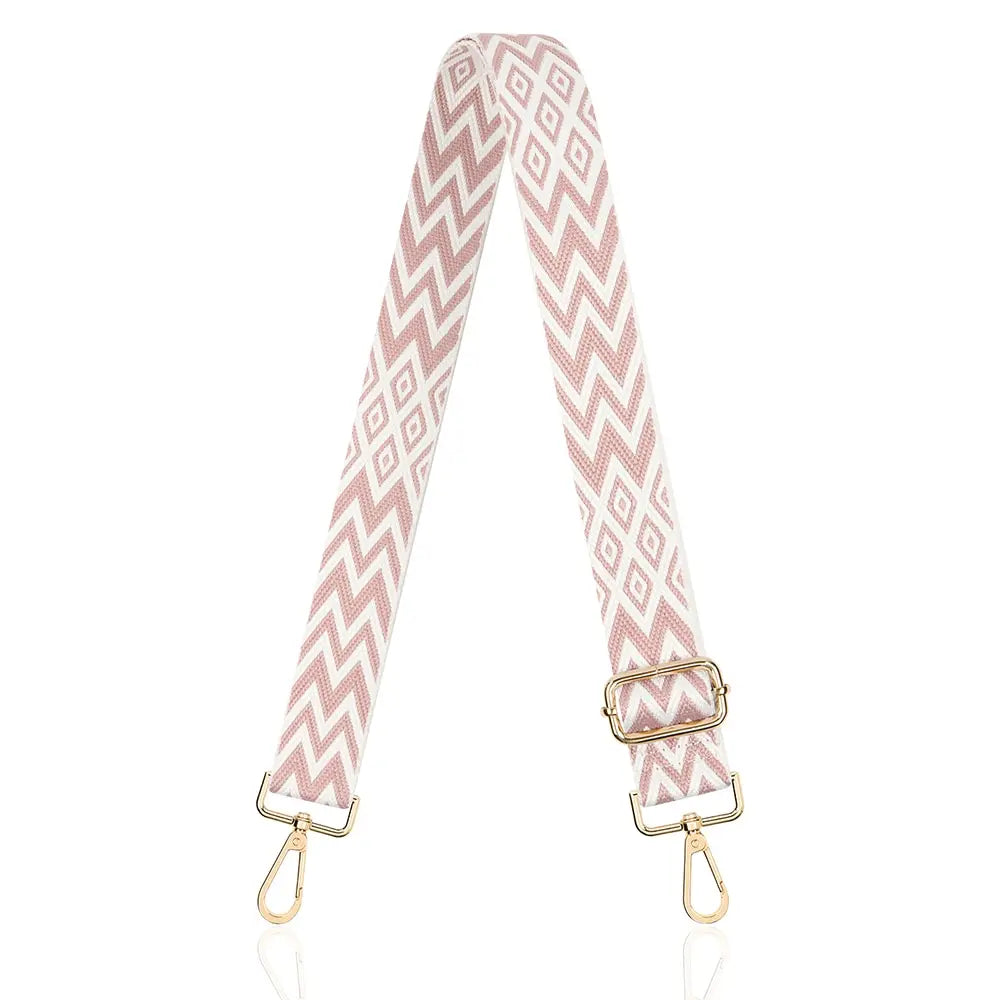 A pink and white chevron patterned nylon crossbody bag strap.