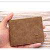 A brown leather wallet is held in a hand, showing the slim design and embossed letter B.