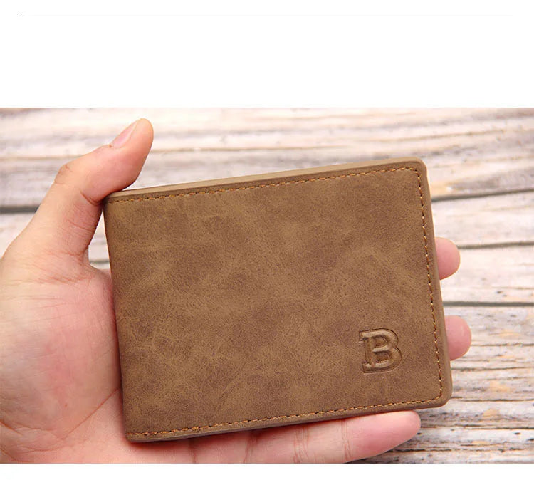 A brown leather wallet is held in a hand, showing the slim design and embossed letter B.