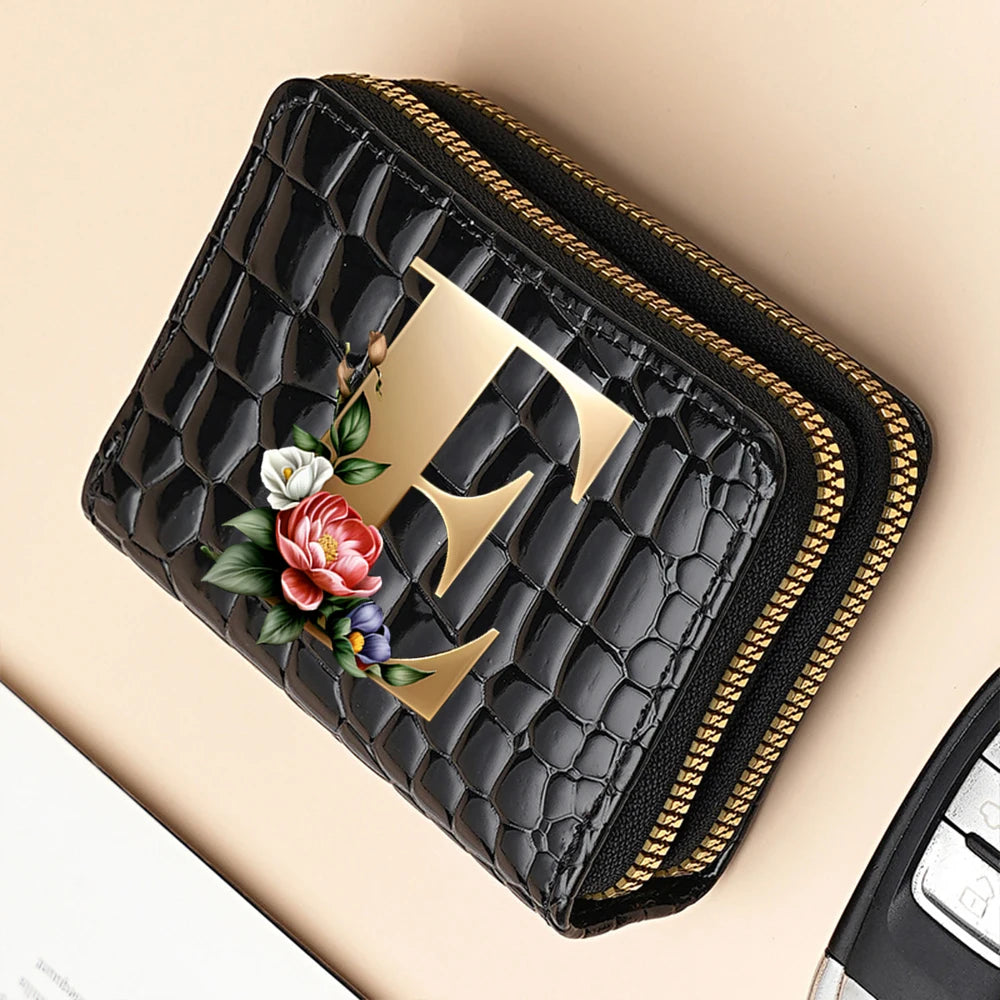 A black PU leather double-zip clutch wallet with a gold geometric print and floral embroidery.