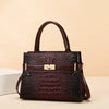 A dark burgundy crocodile embossed PU leather shoulder handbag with a gold buckle.