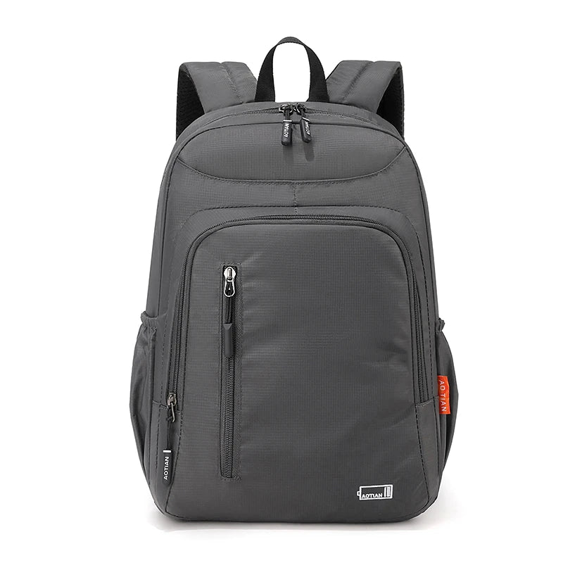 A gray fashion commuter daypack for women with padded straps and multiple compartments.
